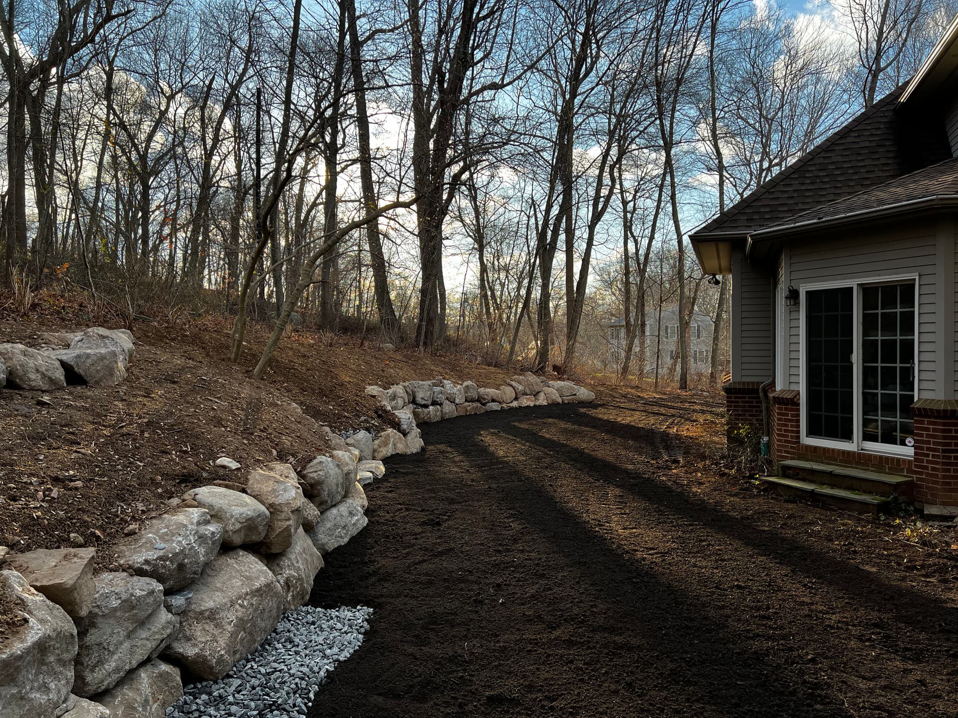 Backyard Water Runoff Fix with Boulder Walls and a Fresh Pathway image