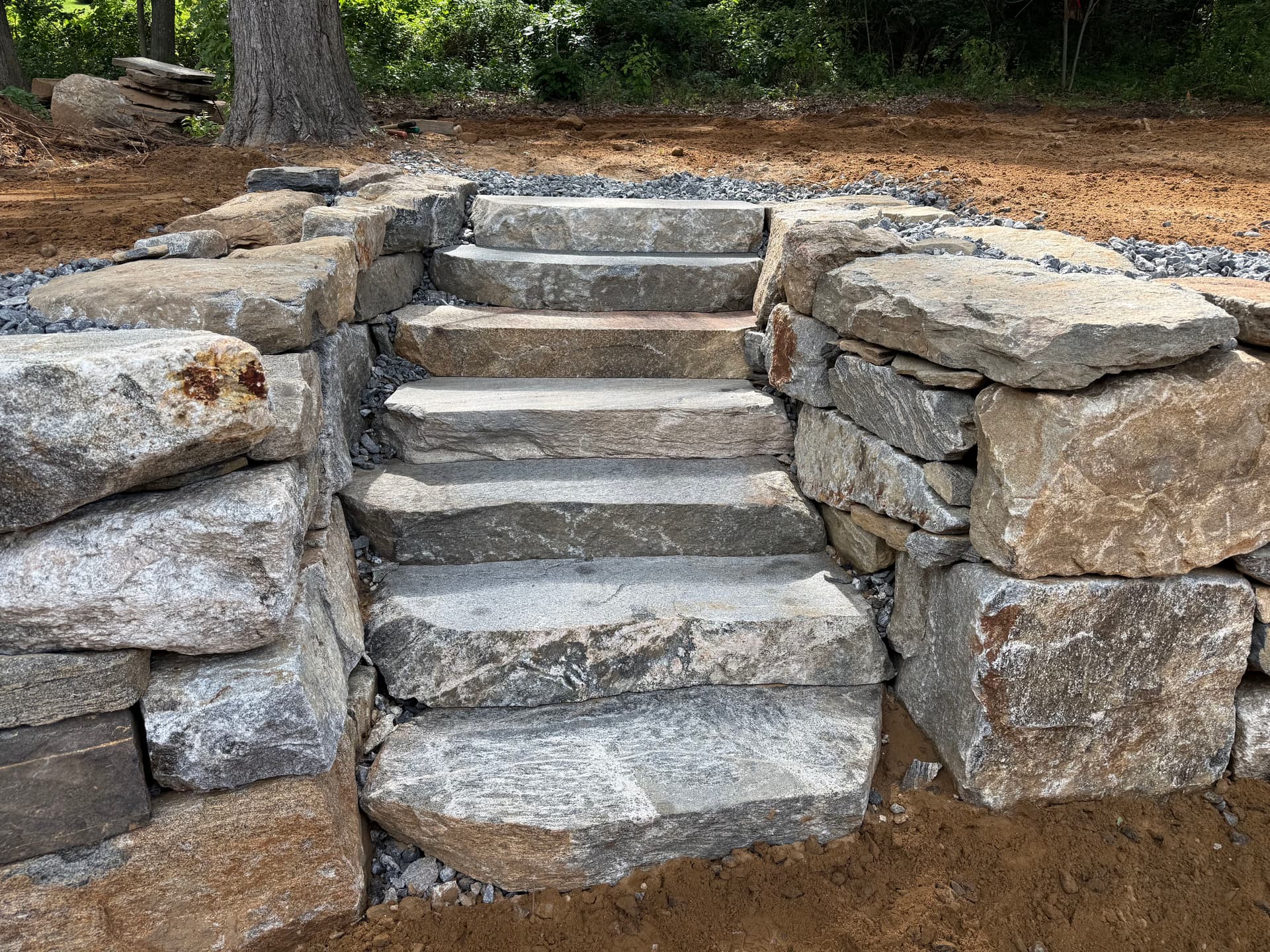 Boulder Retaining Wall and Stone Steps Solve a Runoff Problem image