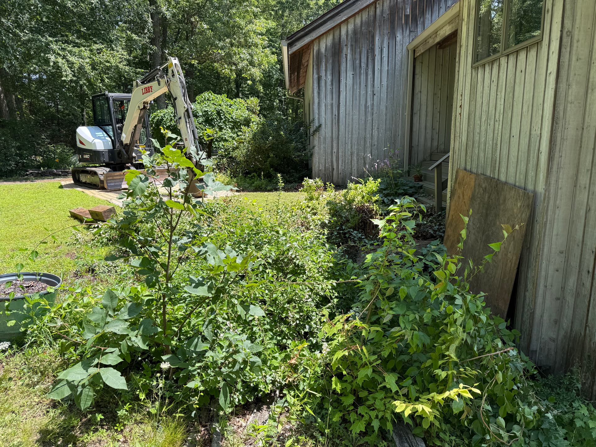 Failing Timber Retaining Wall Rebuilt With Boulders and Proper Drainage image