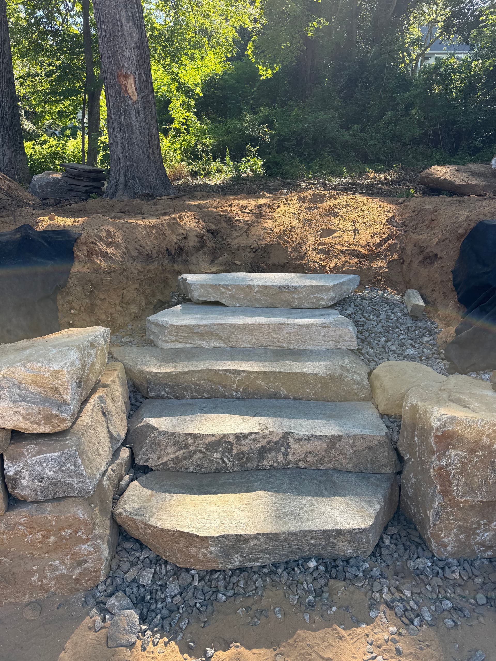 Boulder Retaining Wall and Stone Steps Built for a Sloped Property image